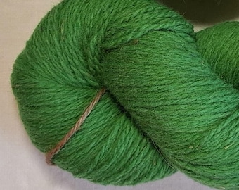 Wool yarn for knitting. Bright green  hand dyed 100 % wool yarn. Natural lanolin yarn.