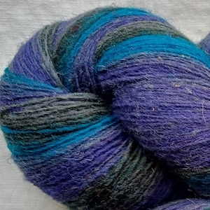 Wool yarn for knitting. High quality multicolor purple, black, striped  yarn . Natural lanolin wool yarn.