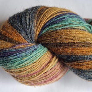 Wool yarn for knitting. High quality multicolor old pink , blue, rust orange striped 100 % wool yarn . Natural lanolin wool yarn.