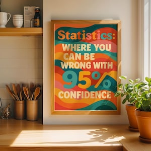 May include: A framed wall art print featuring a wavy, multi-coloured background in shades of orange, red, teal, and yellow. The text reads: Statistics: WHERE YOU CAN BE WRONG WITH 95% CONFIDENCE. The print is displayed in a light wood frame.