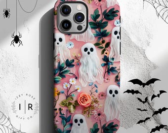 May include: A phone case featuring a pink background with white ghost illustrations, flowers, and green leaves. The case has a glossy finish and a camera cutout. The Izzy Rose Gift Co. logo is visible.