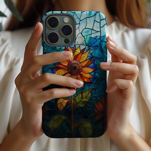 a woman holding up a phone case with a flower on it