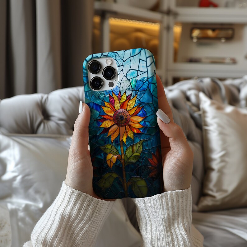 a woman holding up a phone case with a flower on it