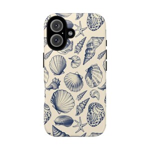 May include: A white phone case with a blue seashell pattern. The case has a cutout for the camera lens and a white background.