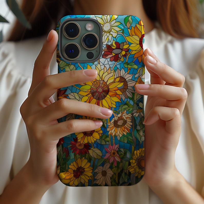 a woman holding up a phone case with flowers on it