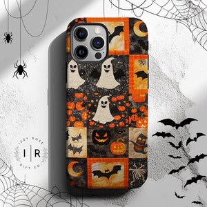 May include: A Halloween-themed phone case featuring a patchwork design with ghosts, bats, pumpkins, and moons in orange, black, and white. The case has a glossy finish and a camera cutout.