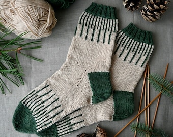 Może przedstawiać: Para skarpet knitted w kolorze zielonym i beżowym. Skarpety mają wzór w paski i są wykonane z miękkiej przędzy.