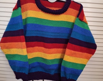 Childs jumper in bright rainbow colours.