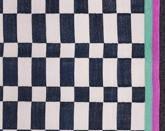 May include: A woven textile with a checkerboard pattern in navy blue and white. The edge features a vertical stripe in light green and magenta. The textile is likely a rug or blanket.