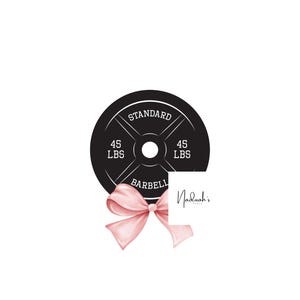 May include: A black weight plate with "STANDARD BARBELL" and "45 LBS" printed on it. A pink bow is tied around the plate with a white square label that says "Nadulah's" in cursive.