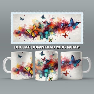 Könnte beinhalten: Eine weiße Keramiktasse mit einem farbenfrohen Aquarelldesign mit Schmetterlingen und Farbspritzern. Das Design umgibt die Tasse.