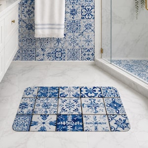 May include: A rectangular bathroom floor mat featuring a grid of various blue and white floral and geometric tile patterns. The mat has rounded corners and a repeating design that mimics traditional ceramic tiles on a white background.