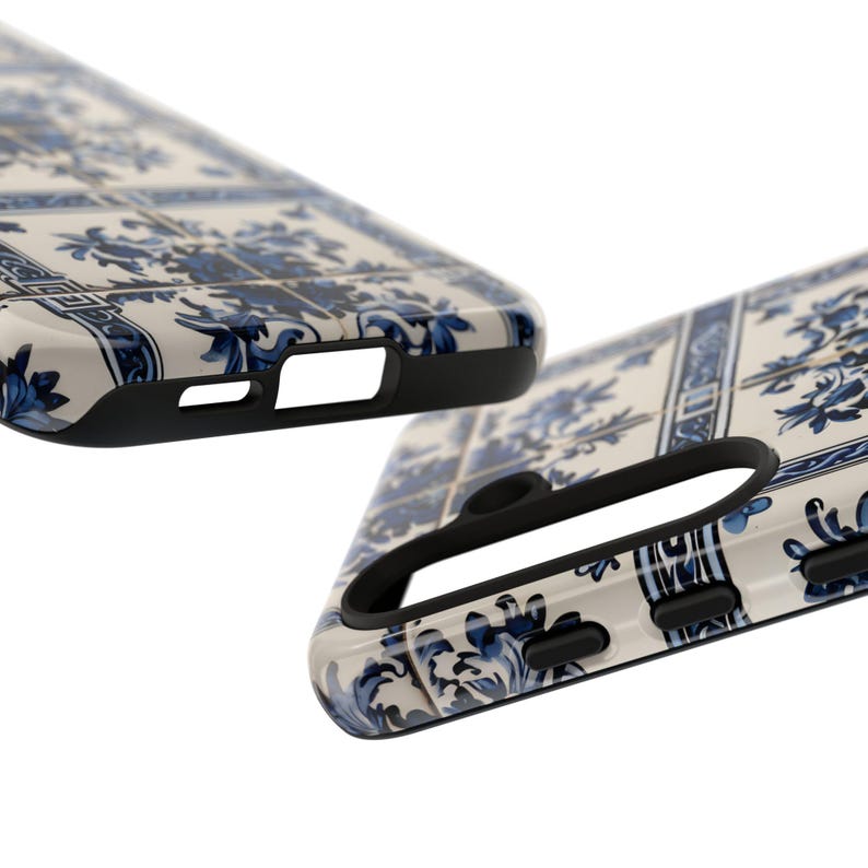 May include: Two phone cases with a white and blue floral tile pattern. The cases have a glossy finish and black edges. The design features a repeating pattern of blue flowers and leaves on a white background. The cases are angled to show the side and top details.
