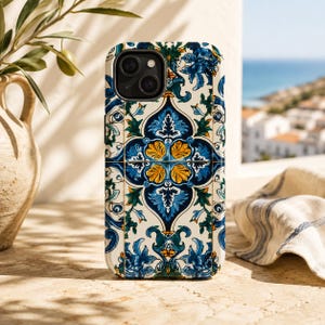 May include: A smartphone case featuring a repeating tile pattern in shades of deep blue, bright yellow, and forest green on an off-white background. The design includes intricate floral and scrollwork motifs arranged in a symmetrical grid layout.