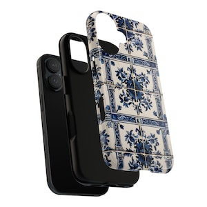 May include: A black smartphone with a protective case featuring a blue and white floral tile design. The case is detached, showcasing the phone's camera and screen. The design resembles traditional Portuguese azulejo tiles.