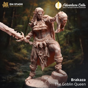 May include: A detailed miniature figurine of a female goblin warrior, holding a sword and a severed goblin head. She is wearing a fur cloak and a leather skirt with bone accents. The figurine is painted in a light brown color and is standing on a rocky base. The text "Brakaza The Goblin Queen" is printed below the figurine.
