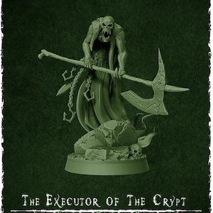 May include: A green plastic miniature figure of a skeletal creature wearing a robe and holding a large axe. The figure is standing on a rocky base with a skull. The text "The Executor of the Crypt" and "The Wraith King's Army" is printed below the figure. The figure is 32mm in diameter.