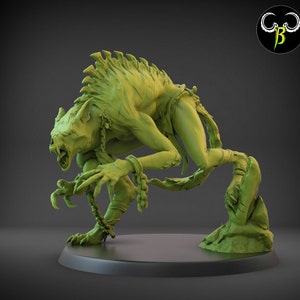 May include: A green, detailed, 3D printed miniature of a monstrous creature with sharp claws, fangs, and a chain around its leg. The creature is in a crouched position, ready to attack.