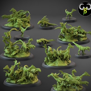 May include: A collection of 10 miniature green dinosaur figurines, each posed in a different action, on circular bases. The dinosaurs are arranged in a circle on a gray background.