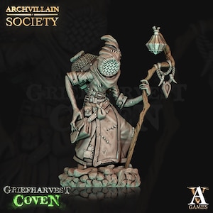 May include: A detailed miniature figure of a hooded figure with a lantern, a staff, and a bag. The figure is painted in a muted gray color scheme and is standing on a rocky base. The figure is part of the Griefharvest Coven collection.