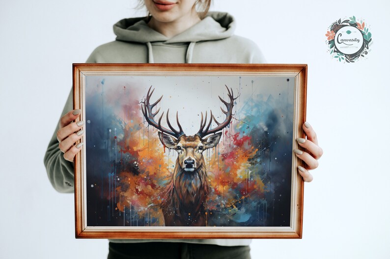 May include: A framed watercolor painting of a deer with large antlers standing in front of a colorful abstract background. The background features shades of blue, orange, yellow, and red.