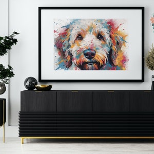 May include: A colorful abstract painting of a dog's face. The dog is a light brown color with a white muzzle and black nose. The background is a white canvas with splashes of color in shades of blue, green, yellow, orange, and red.