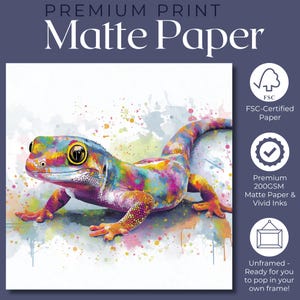 May include: A colorful gecko print on matte paper. The gecko is depicted with vibrant hues of blue, yellow, pink, and green, set against a white background with watercolor-style paint splatters. The print is unframed and ready to be framed.