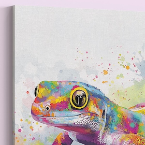 May include: A colorful watercolor painting of a gecko. The gecko's skin is a vibrant mix of blue, yellow, pink, and green. The artwork has a watercolor effect with paint splatters in the background. The gecko's eye is a large, dark circle.