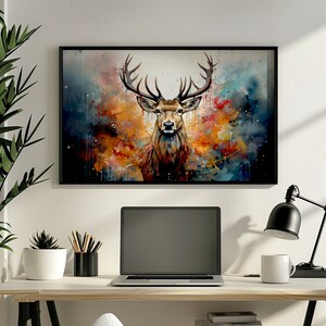 May include: A framed watercolor painting of a stag with large antlers standing in front of a colorful abstract background. The stag is looking directly at the viewer.