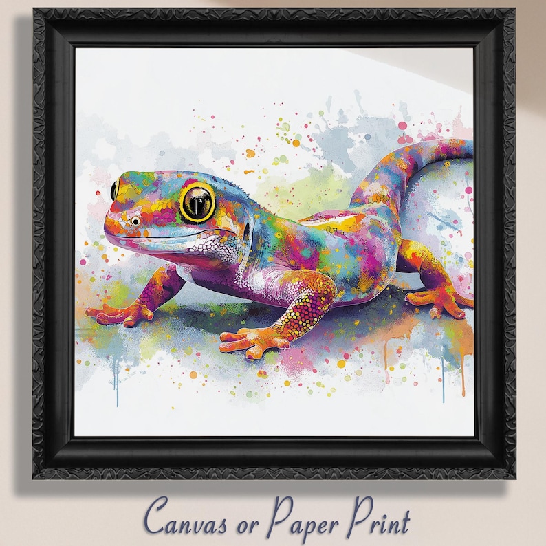 May include: A framed print featuring a colorful gecko in a watercolor style. The gecko is depicted with vibrant hues of blue, yellow, pink, and purple. The artwork is set against a white background with paint splatters. The frame is black and ornate. The text "Canvas or Paper Print" is at the bottom.