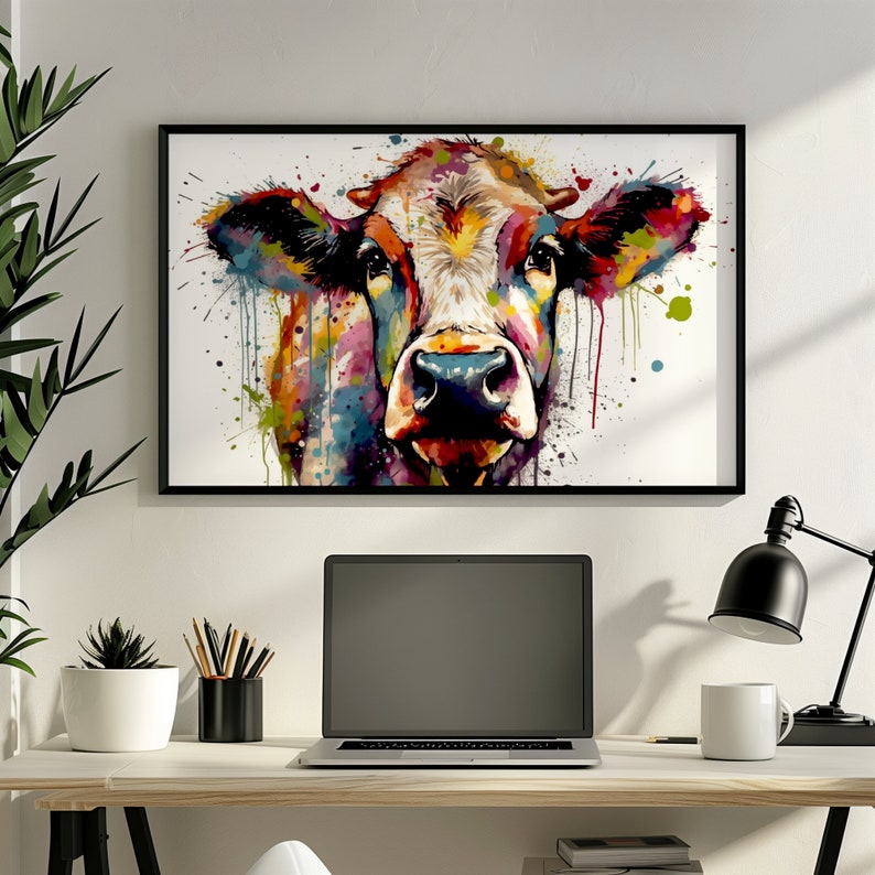 May include: A colorful abstract painting of a cow's head with splashes of paint in shades of blue, green, yellow, red, and pink. The cow's eyes are black and the nose is brown. The background is white.