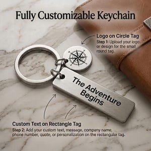May include: A silver-toned metal keyring featuring a circular tag with a compass rose engraving and a rectangular tag engraved with the text The Adventure Begins. The text Fully Customizable Keychain, Logo on Circle Tag, and Custom Text on Rectangle Tag are visible.