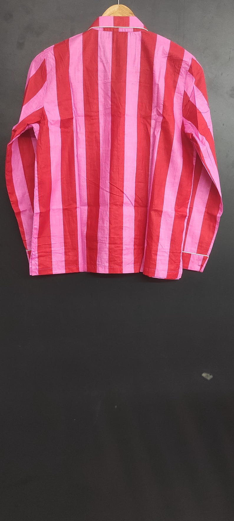 K&ouml;nnte beinhalten: Ein lang&auml;rmliges Hemd mit roten und pinkfarbenen Streifen und einem wei&szlig;en Kragen.