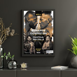 May include: Framed UFC 296 poster featuring Edwards vs. Covington and Pantoja vs. Royval 2. The poster has a black frame and displays images of the fighters with event details. The date of the event is December 16th.