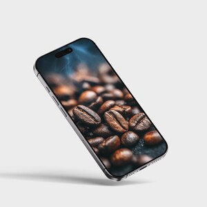 May include: A silver smartphone displays a close-up image of roasted coffee beans. The beans are a rich brown color, with visible textures and details. The phone is angled, showcasing the screen's vibrant image against a neutral background.