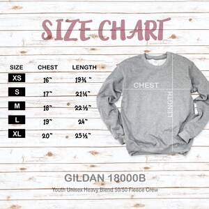 May include: Size chart for youth unisex fleece crew sweatshirts in sizes XS to XL. The chart shows chest and length measurements in inches. The brand is Gildan 18000B.