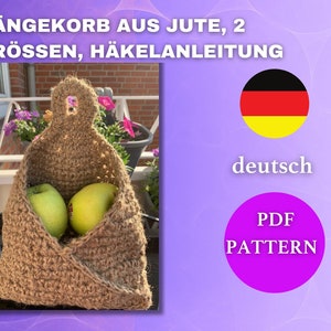 May include: A brown jute hanging basket with two green apples inside. The basket has a loop handle and is crocheted. The image also includes text in German that says "HÄNGEKORB AUS JUTE, 2 GRÖSSEN, HÄKELANLEITUNG" and a German flag. The text "deutsch" and "PDF PATTERN" are also included in the image.