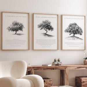 May include: Three black and white framed prints with illustrations of trees and text about the Parable of the Fig Tree, Oaks of Righteousness, and the Parable of the Mustard Seed. The prints are hanging on a white wall above a wooden table with a white armchair and a wooden coffee table.