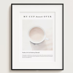 Puede incluir: Una impresión enmarcada blanca con un fondo beige y una taza de café blanca. El texto "MY CUP Runneth OVER" está en la parte superior de la impresión. El texto "Psalm 23:5 (A Psalm of David)" está debajo de la imagen. El texto "Thou preparest a table before me in the presence of mine enemies: thou anointest my head with oil; my cup runneth over. Surely goodness and mercy shall follow me all the days of my life: and I will dwell in the house of the LORD for ever." está en la parte inferior de la impresión.