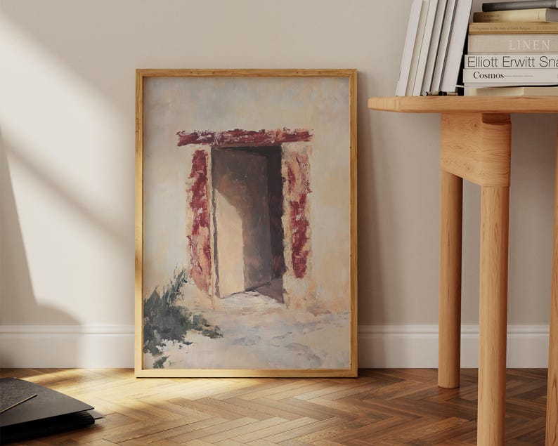 Pode incluir: Uma pintura emoldurada de uma porta com um arco de padr&atilde;o vermelho e branco. A porta est&aacute; aberta e leva a um quarto branco com uma fonte de luz que vem do lado esquerdo da imagem.