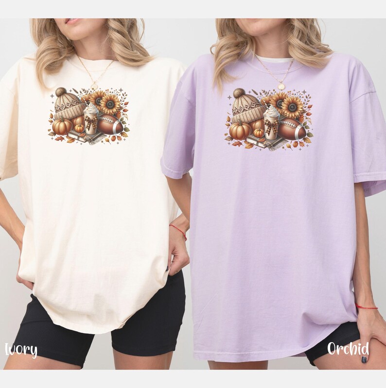 May include: Two t-shirts with a fall-themed design featuring a coffee cup, a football, pumpkins, and a hat. The t-shirts are in ivory and orchid colors.