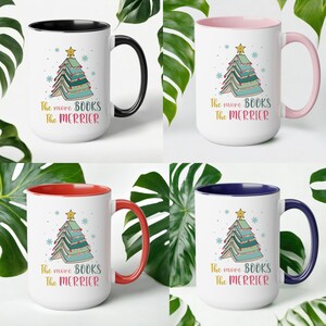 May include: Four different color mugs with a white background and a colored rim. Each mug features a Christmas tree made of stacked books with the text "The more BOOKS The MERRIER" printed below.