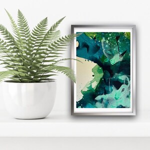 May include: Abstract art print with a teal, green, and white color scheme. The print is framed in a silver frame.