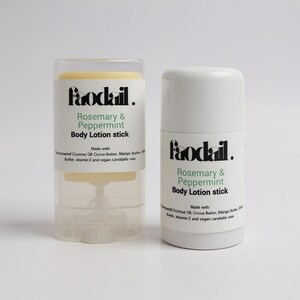 May include: Two white body lotion sticks with the text "Faodail. Rosemary & Peppermint Body Lotion stick" in black and green. One stick is in a clear plastic case. The lotion is made with coconut oil, cocoa butter, mango butter, vitamin E, and vegan candelilla wax.