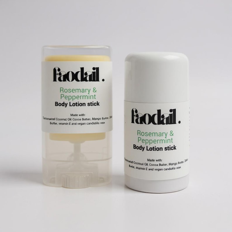 May include: Two white body lotion sticks with the text "Faodail. Rosemary & Peppermint Body Lotion stick" in black and green. One stick is in a clear plastic case. The lotion is made with coconut oil, cocoa butter, mango butter, vitamin E, and vegan candelilla wax.