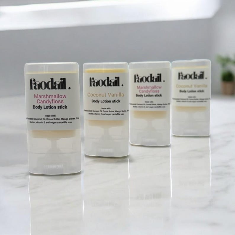 May include: Four clear body lotion sticks with white labels and the brand name "Paodail." The labels read "Marshmallow Candyfloss" and "Coconut Vanilla." The lotion sticks are on a white surface.