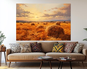 May include: A large canvas print depicting a rural landscape at sunset. The artwork features golden hay bales scattered across a field of dry grass under a sky of orange, yellow, and gray hues. The scene evokes a sense of warmth and tranquility.