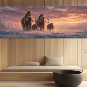 May include: A panoramic canvas print depicts a family of woolly mammoths walking across a snowy landscape under a sunset sky. The mammoths are brown with large tusks, set against a backdrop of pink, orange, and purple hues.