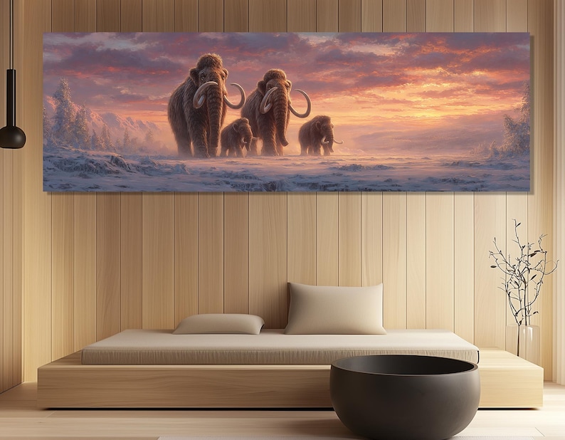 May include: A panoramic canvas print depicts a family of woolly mammoths walking across a snowy landscape under a sunset sky. The mammoths are brown with large tusks, set against a backdrop of pink, orange, and purple hues.
