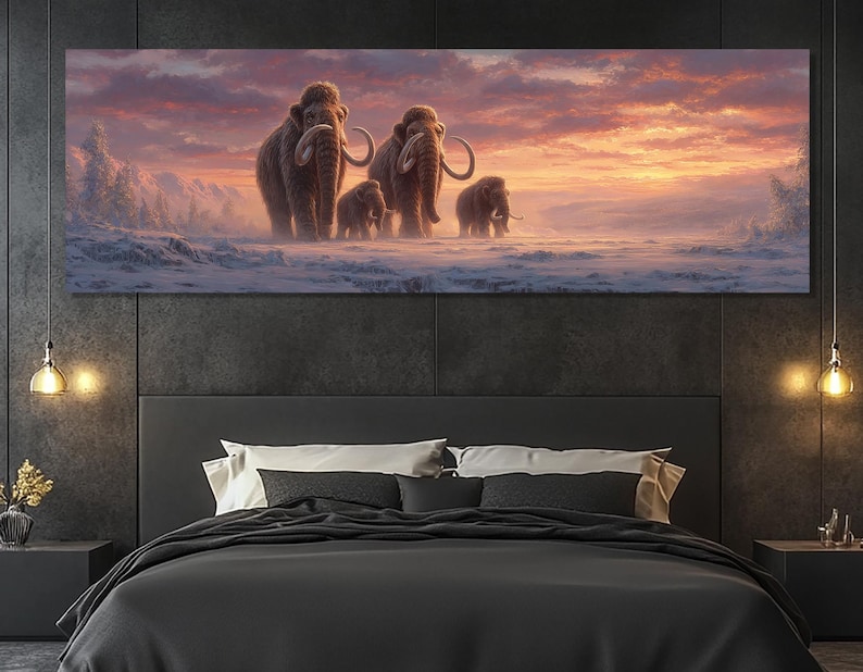 May include: A panoramic canvas print depicts a family of woolly mammoths traversing a snowy landscape under a vibrant sunset. The artwork features detailed depictions of the animals and a warm color palette of oranges, pinks, and purples.